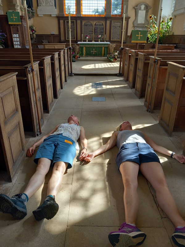 Sally and Charlotte laying on the cool church floor